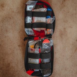 Trauma solo first aid kit open on ground